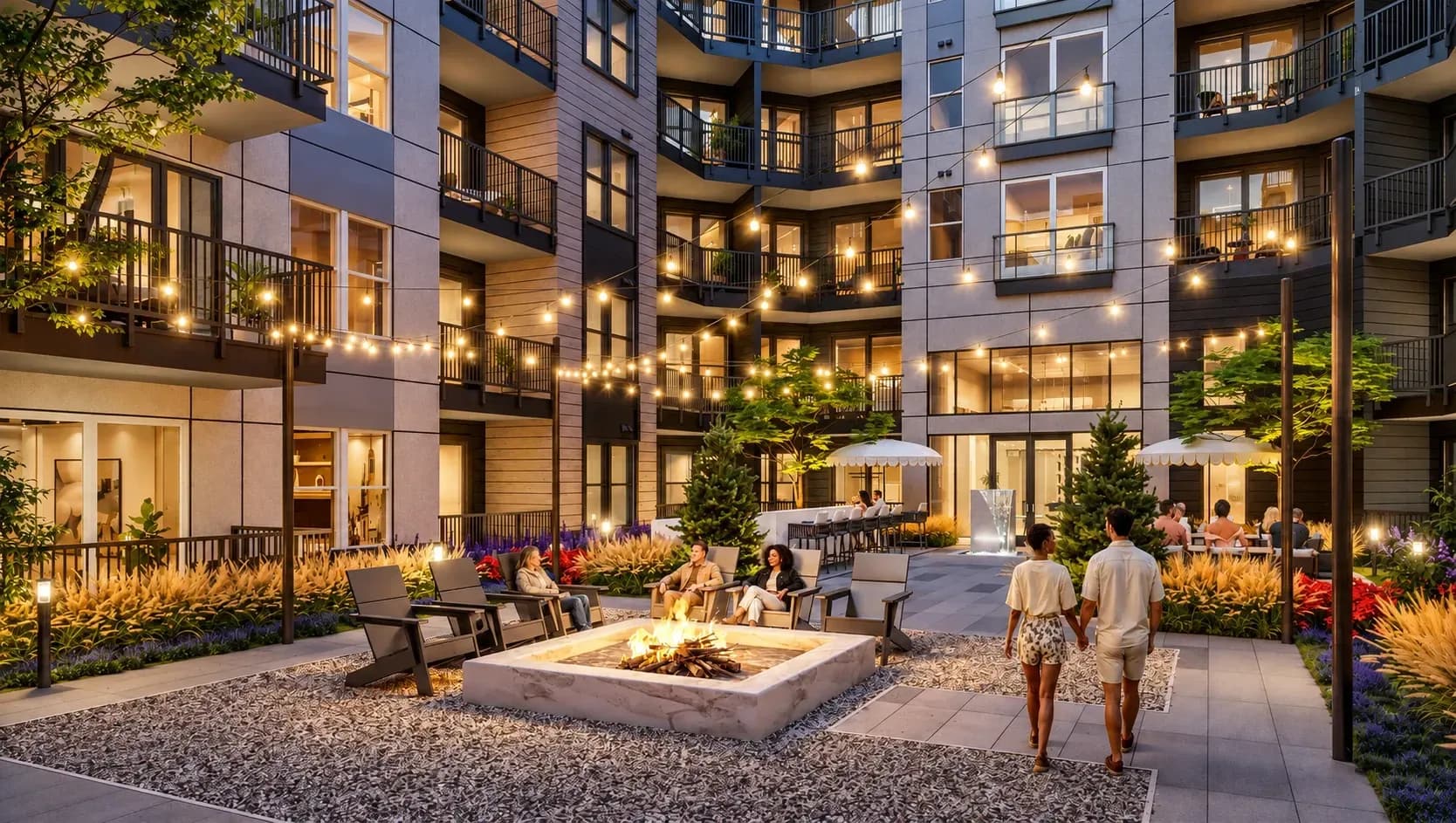 Modern residential courtyard at dusk with central fireplace, seating areas, and illuminated apartment buildings surrounding the space.